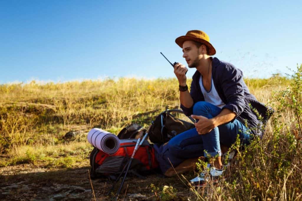 a man using walkie talkie during hike