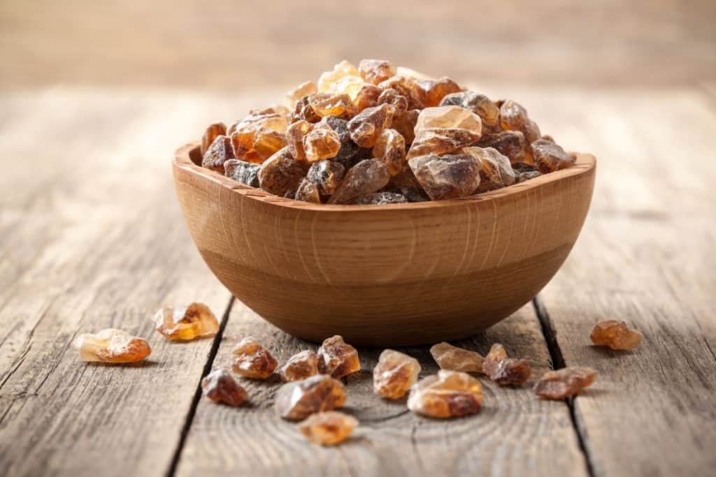 brown sugar rock candy in a wooden bowl on top of the table