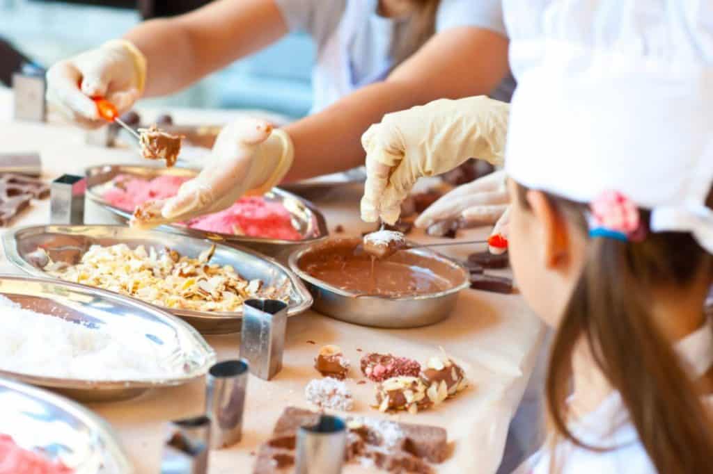 girls making candy chocolates in the pantry