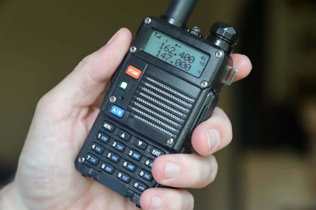 man holding a ham radio walkie talkie