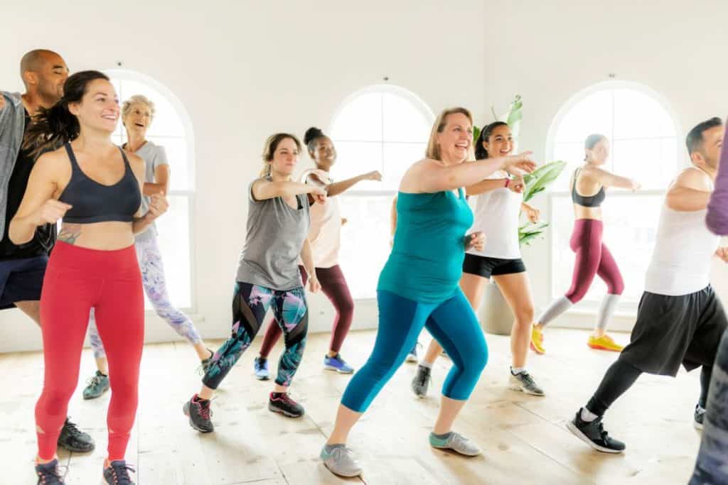 mixed adult dancing zumba in a gym