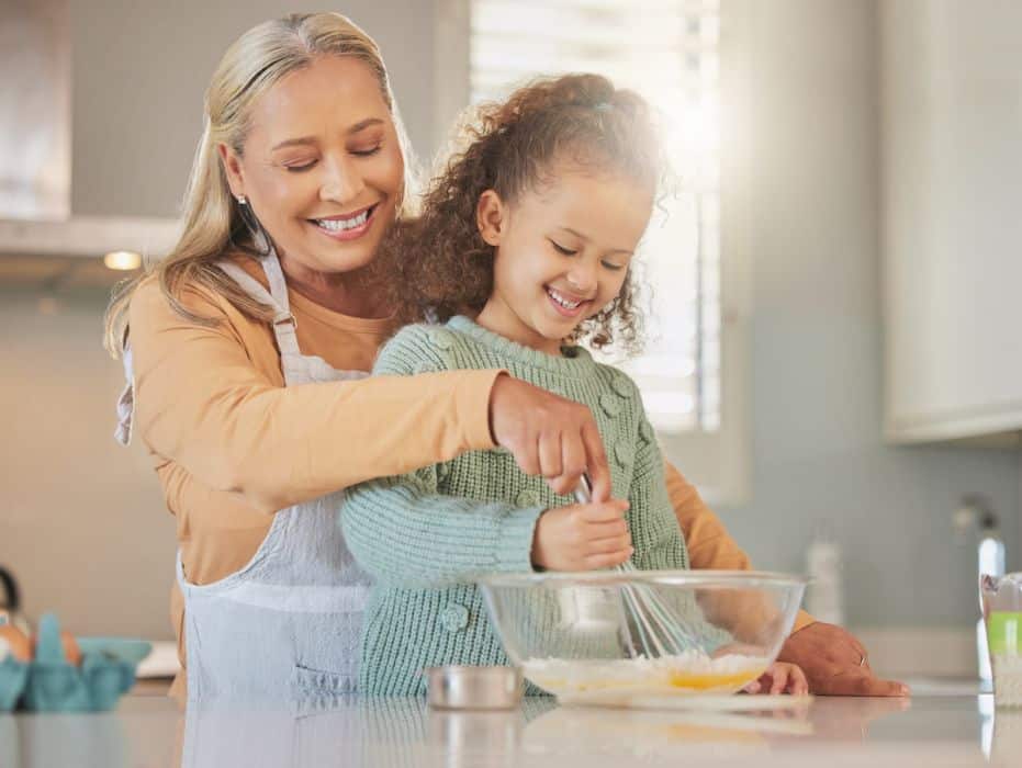 woman baking with daughter in the kitchen
