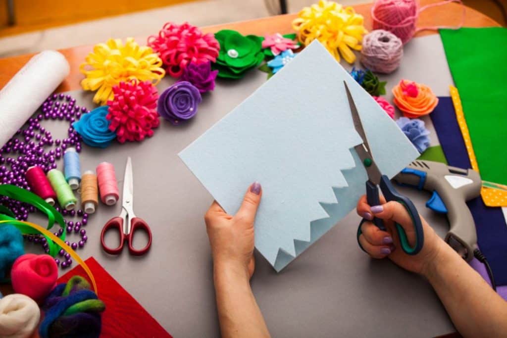 woman doing arts and crafts with colorful materials