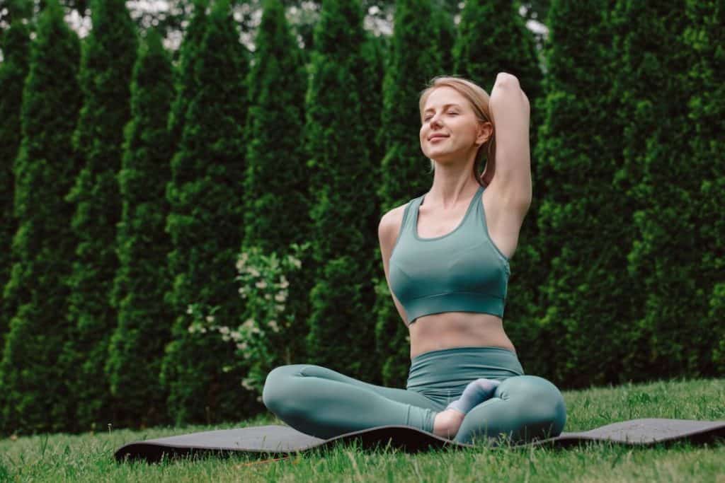 woman doing yoga at the garden