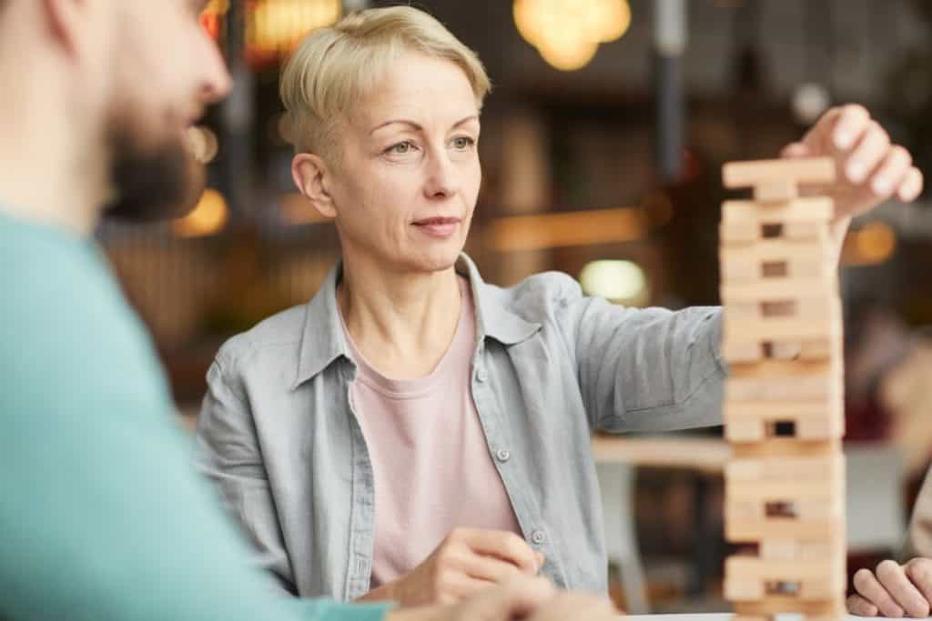 woman in her 50s playing Jenga