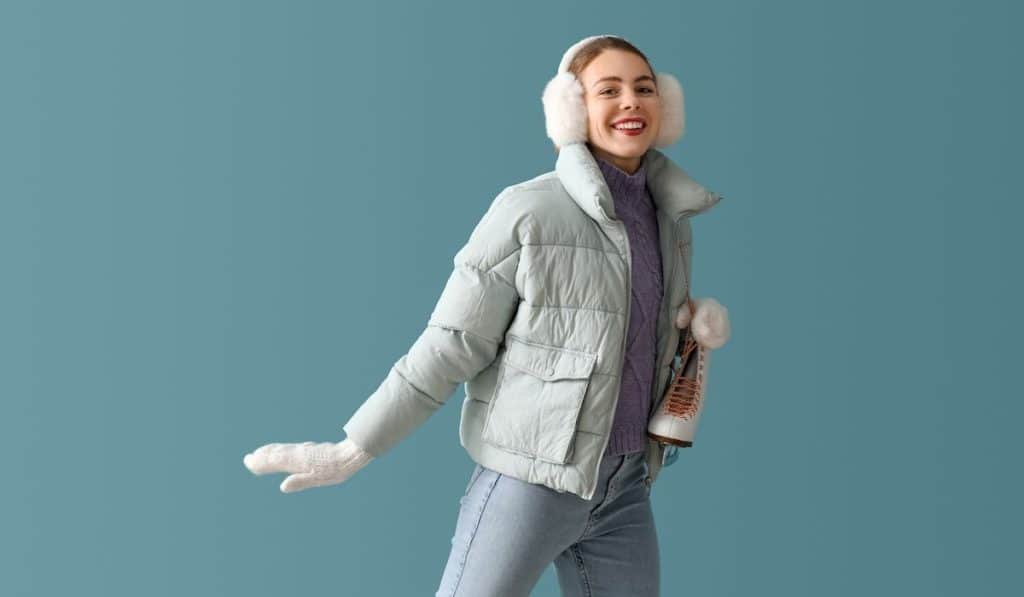 beautiful woman wearing winter clothes going for skating