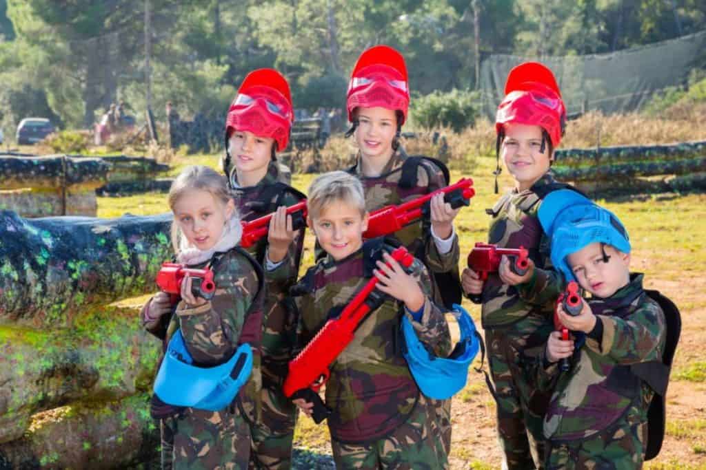 a group of young children in gears for paintball