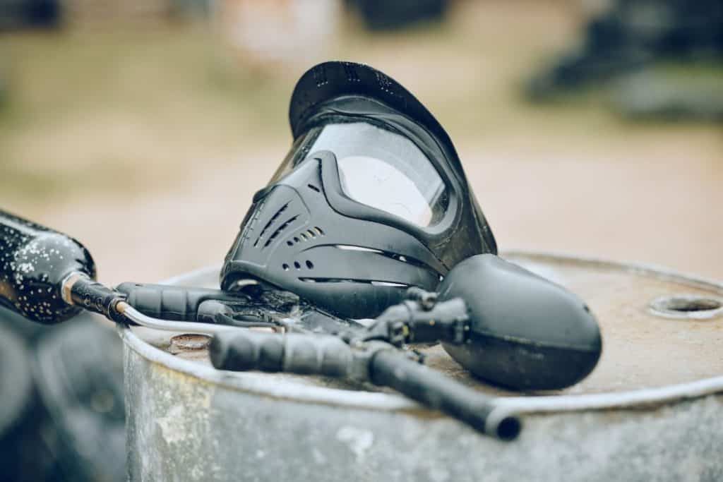 paintball equipment on a barrel in the field