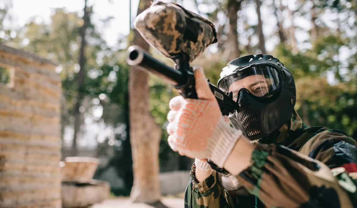 young guy playing paintball