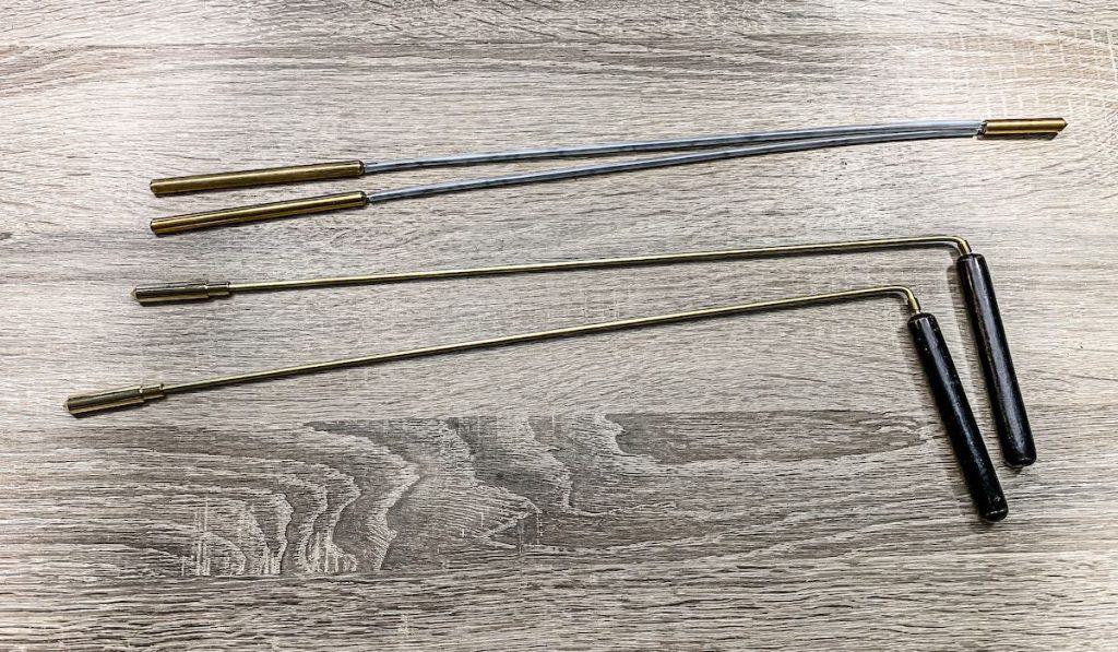 2 pairs of divining rods on a wooden table