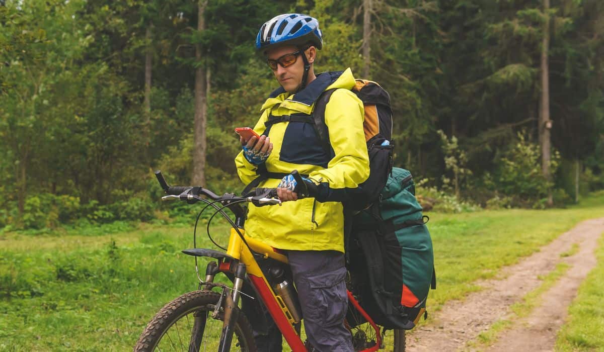 bikepacker stops in the middle of the forest