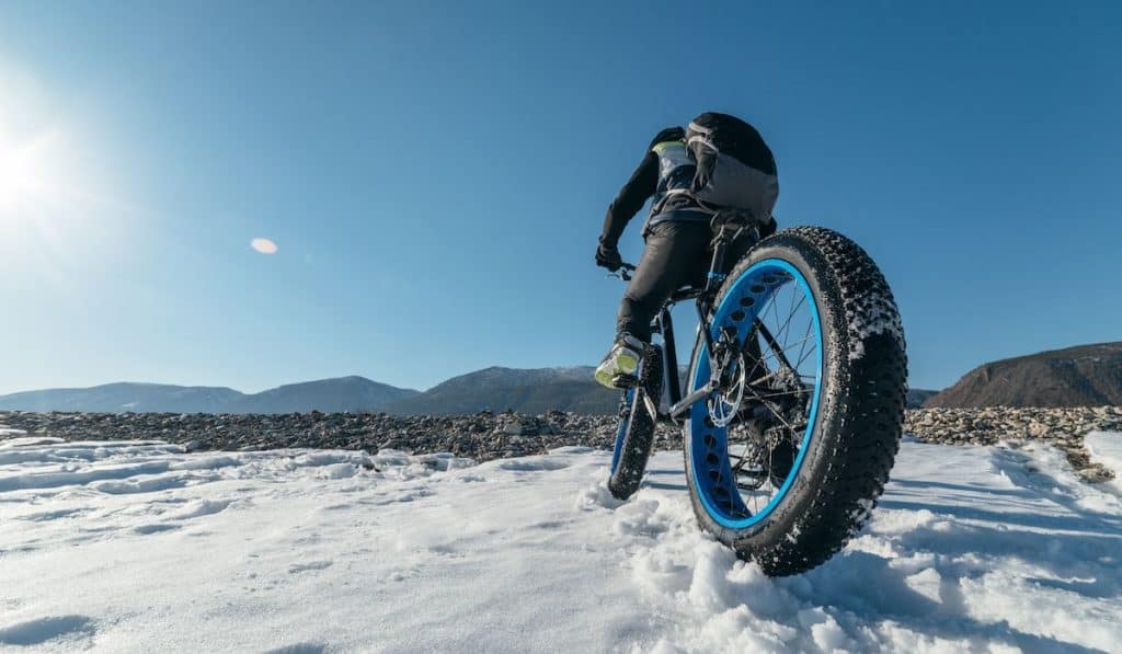 bikepacker using a fat bike on snow