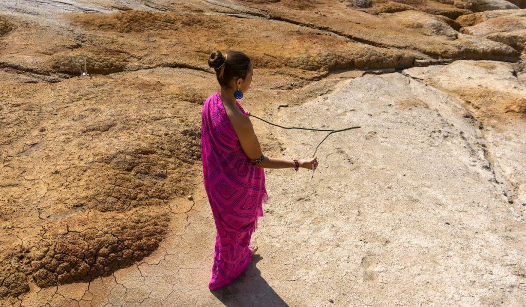 ethnic woman using dowsing to search for water