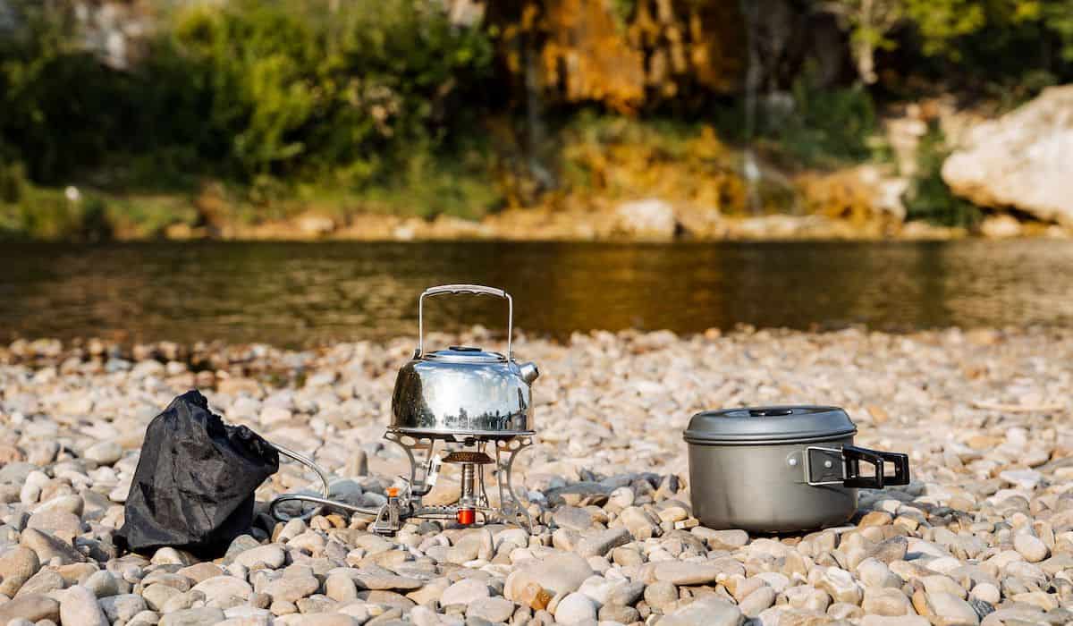 outdoor cookware ready to be cleaned near a river