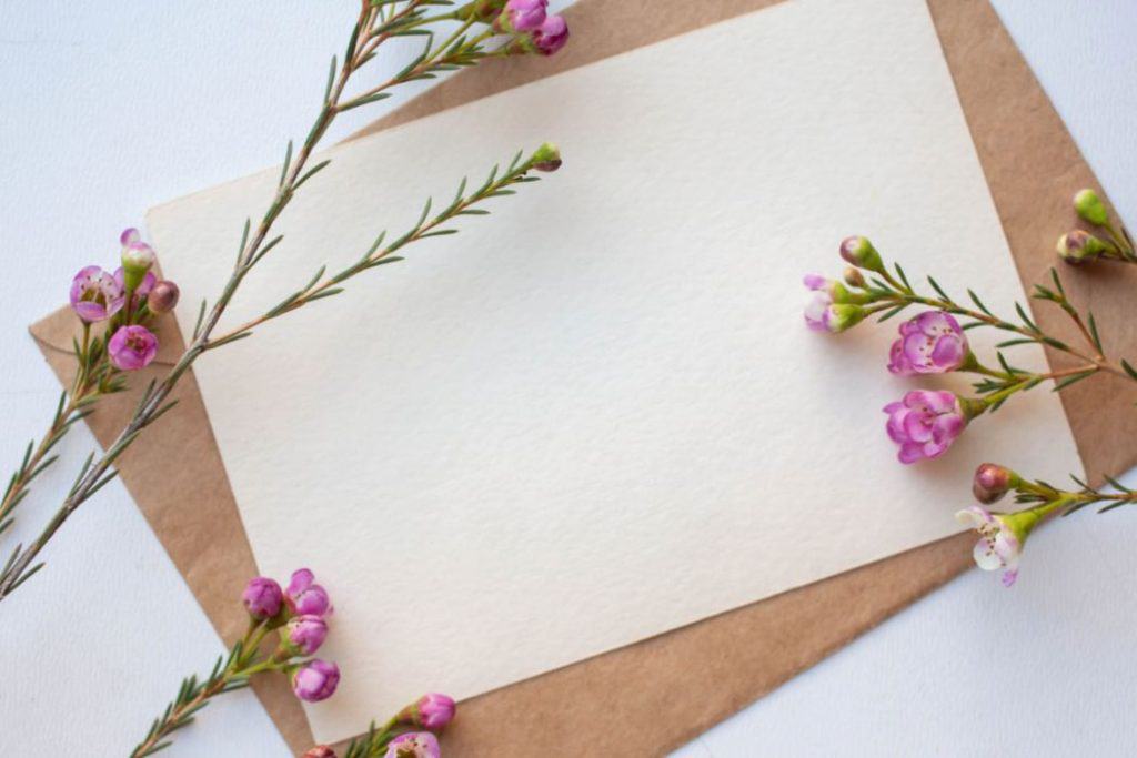purple flowers on the corner of the wax paper on top of the cardboard
