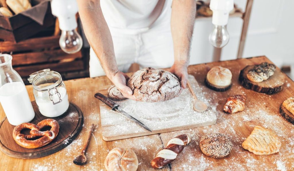 baker making delicious and freshly baked bread and pastry