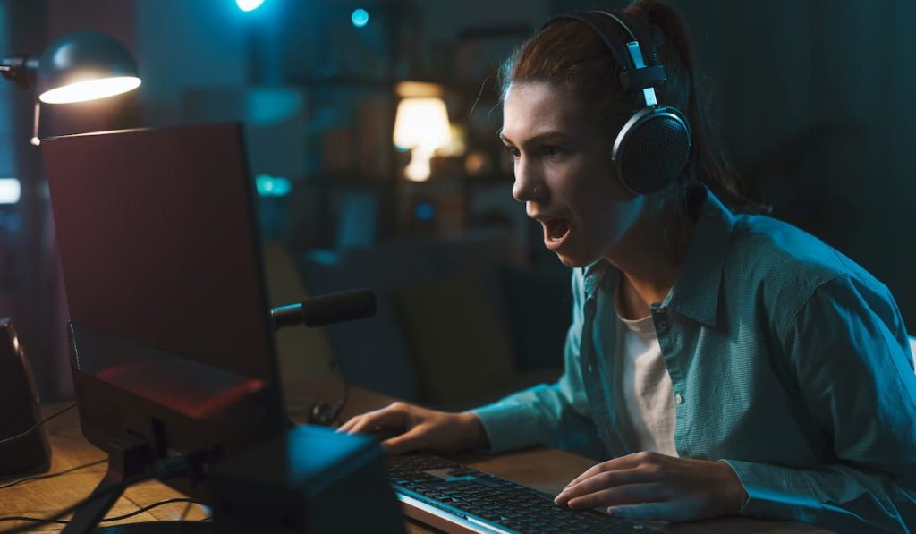 woman playing online video games at home