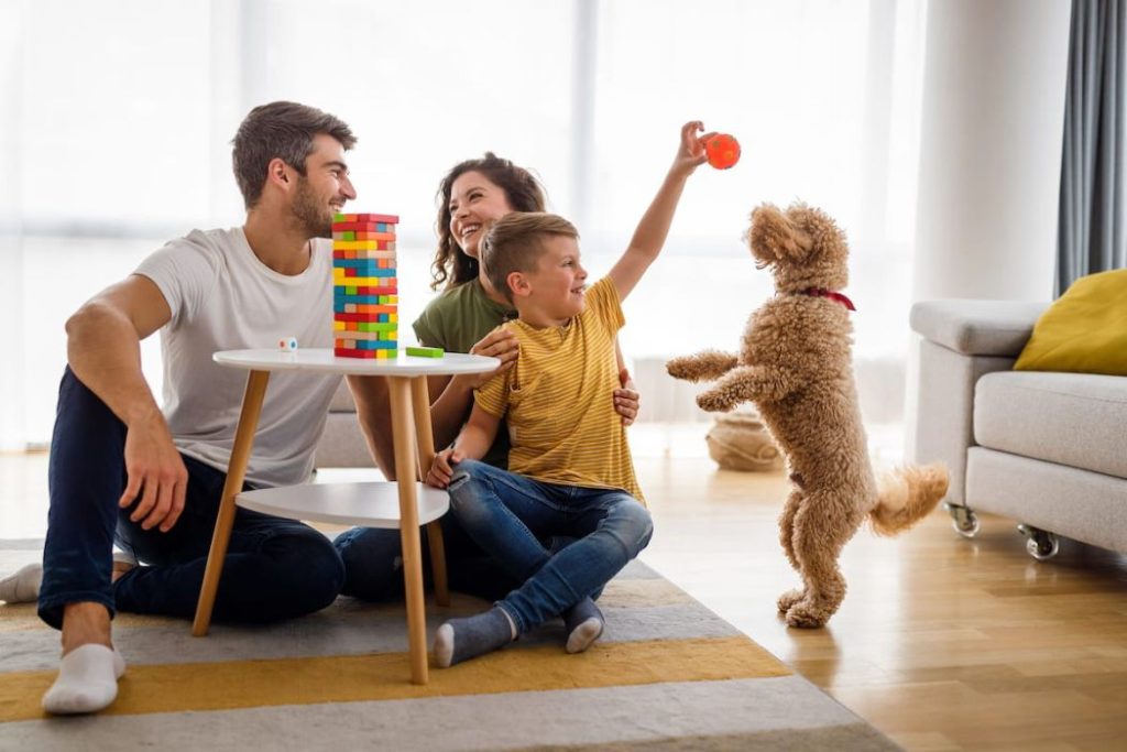 Happy family having fun while playing board game at home 