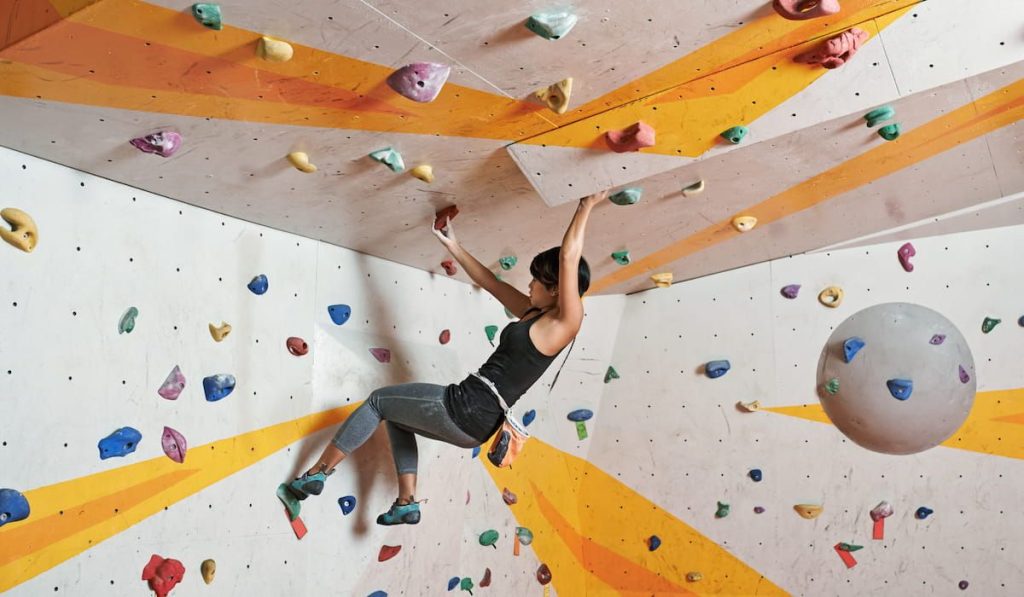 woman doing indoor rock climbing 