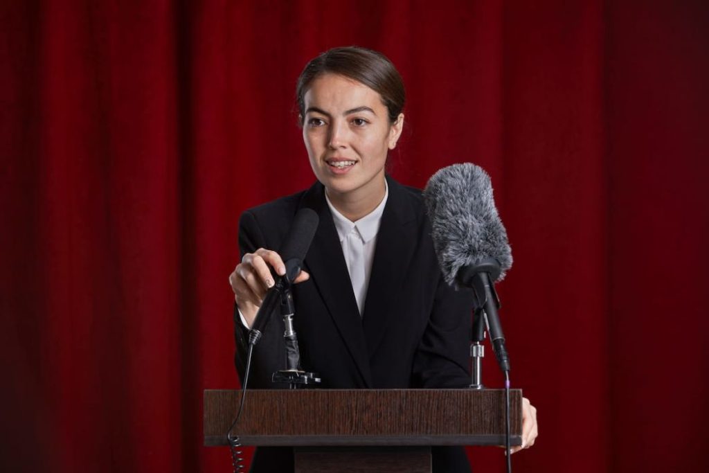 woman giving a speech on stage 