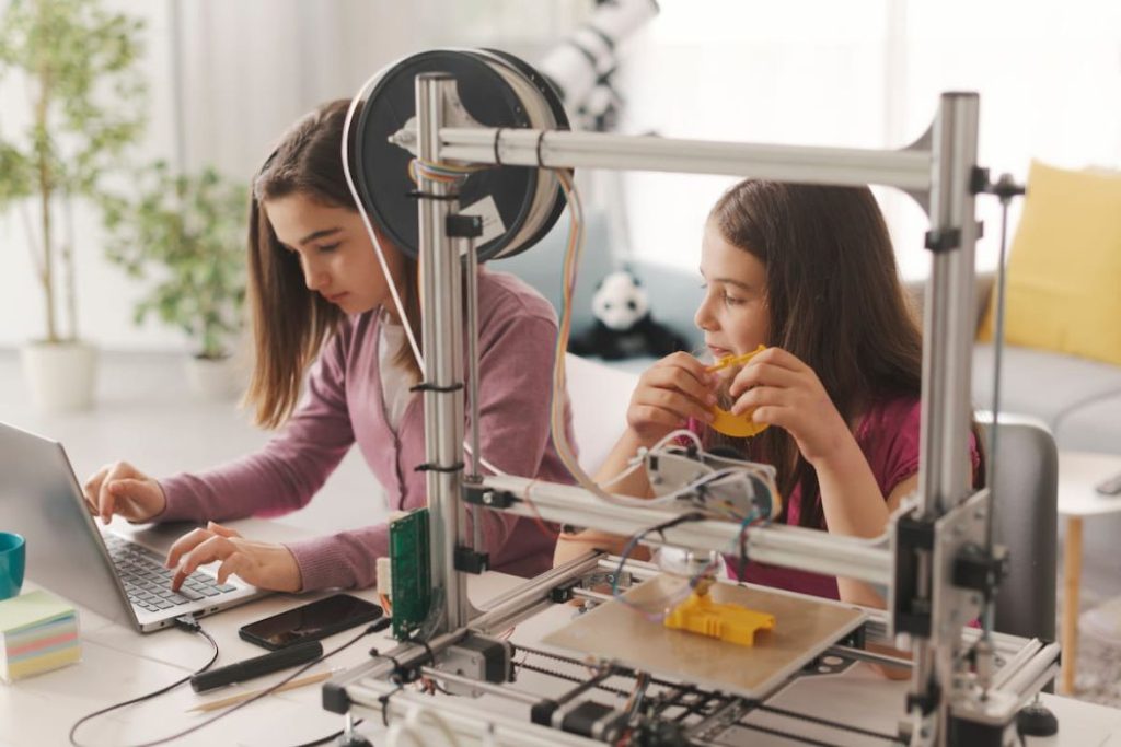 young girls learning 3D printing at home as hobby 