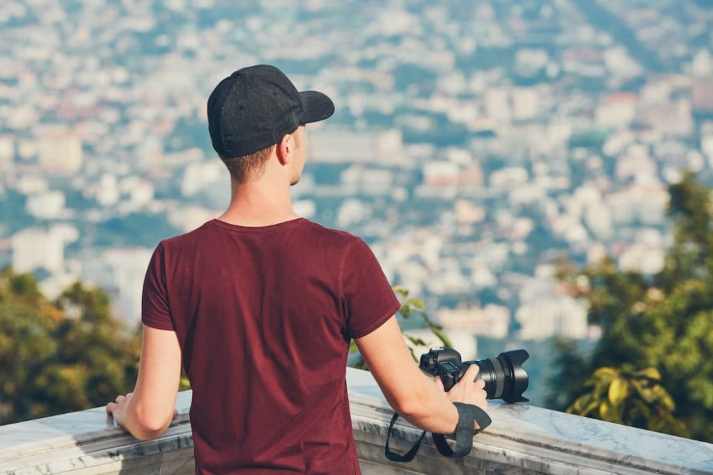 young photographer holding a camera looking for inspiration 