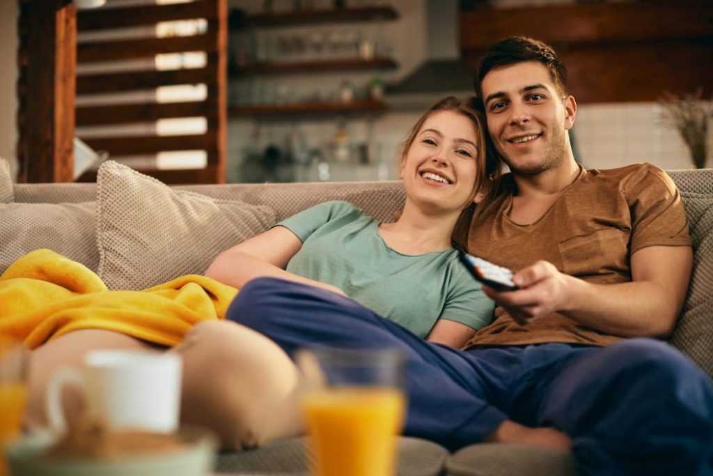 couple watching movie while relaxing on the sofa
