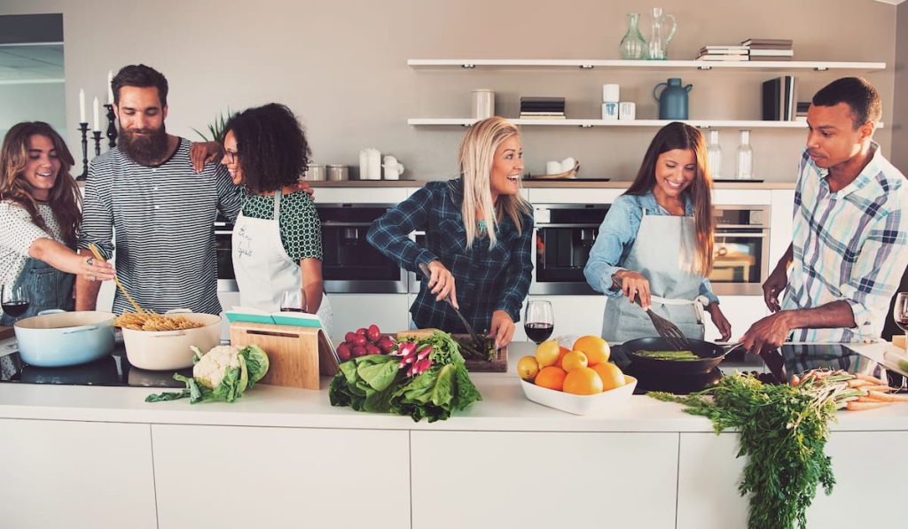 friends cooking a meal together, enjoying each other's company