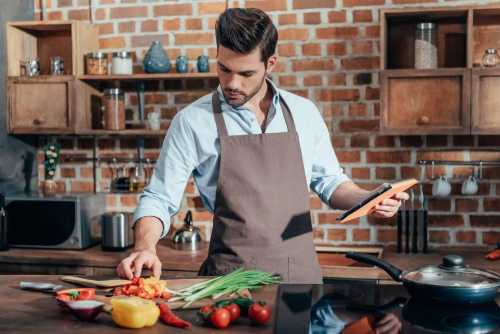 young chef preparing ingredients for the recipe his cooking