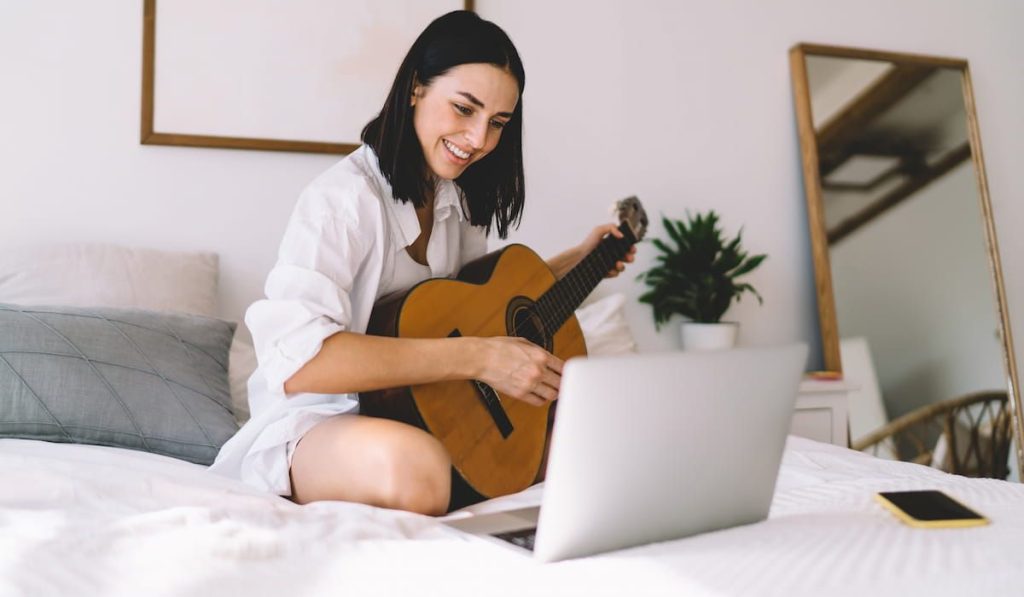 woman enjoying her hobby playing musical instrument