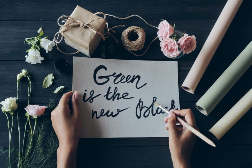 woman writing calligraphy with paintbrush 