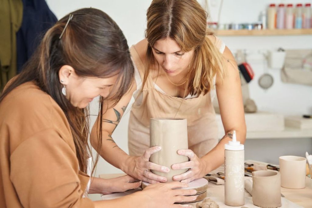 women learning to work with clay in a pottery workshop 