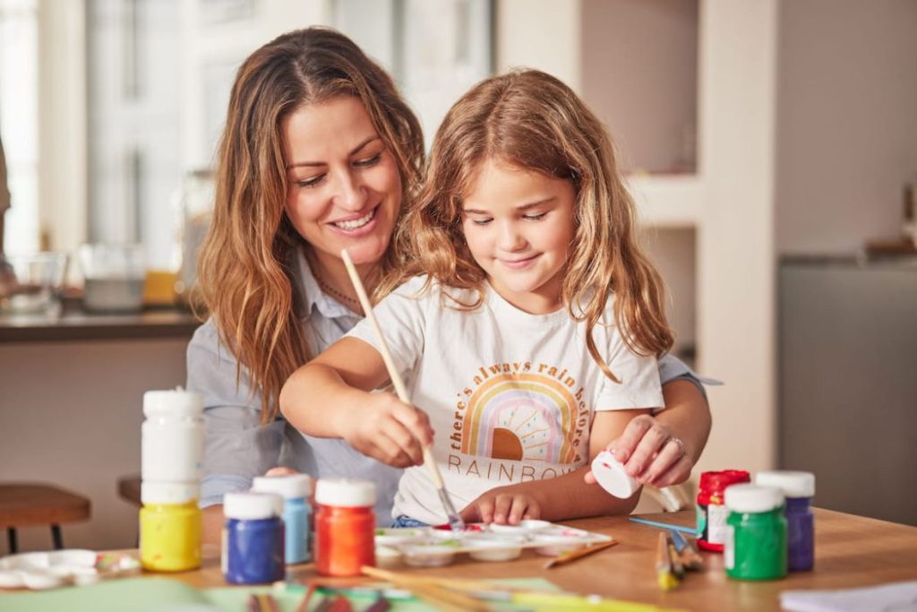 A Girl with ADHD painting with her mother 