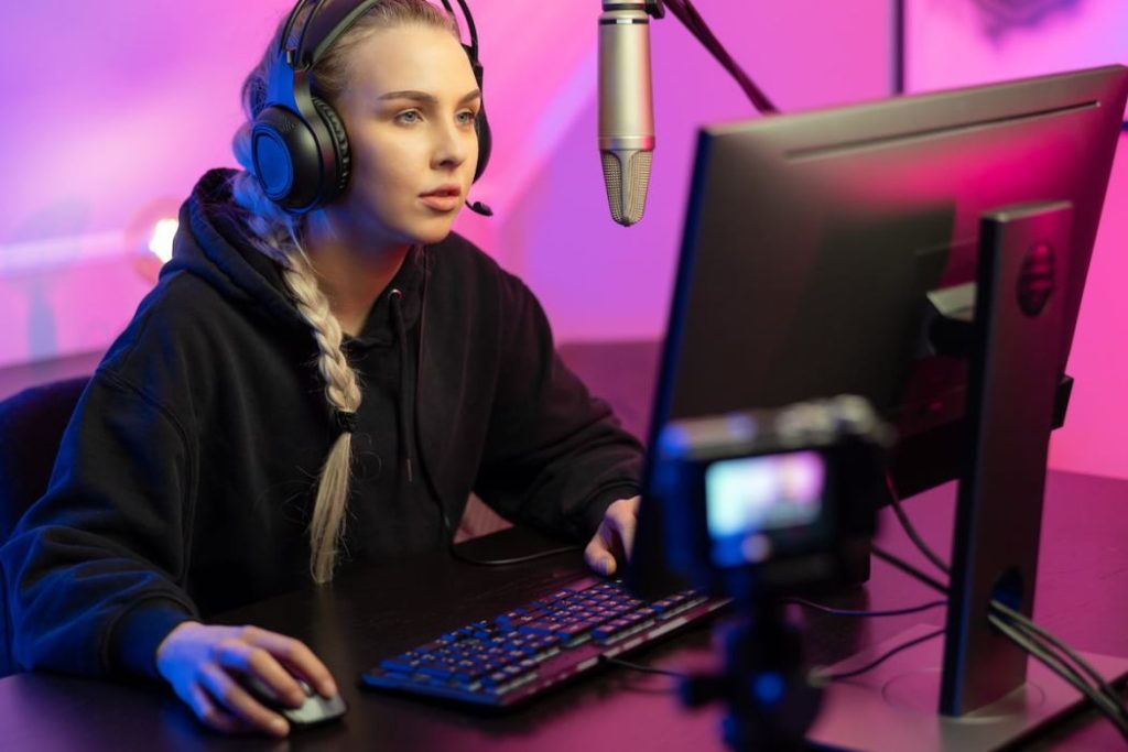 professional e-sport gamer girl streaming while playing computer video game 