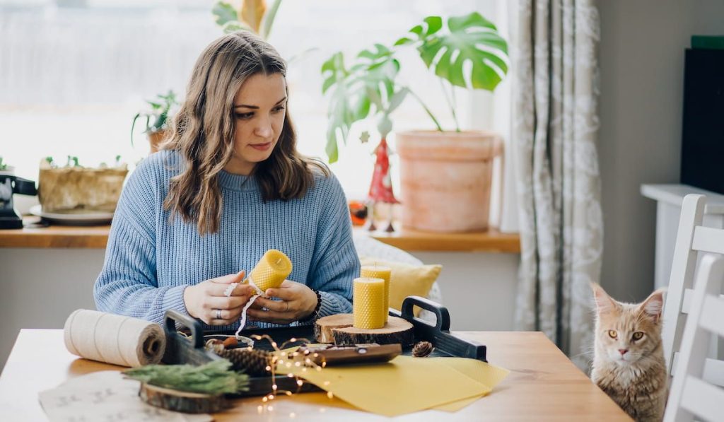 woman making natural wax candles at home 