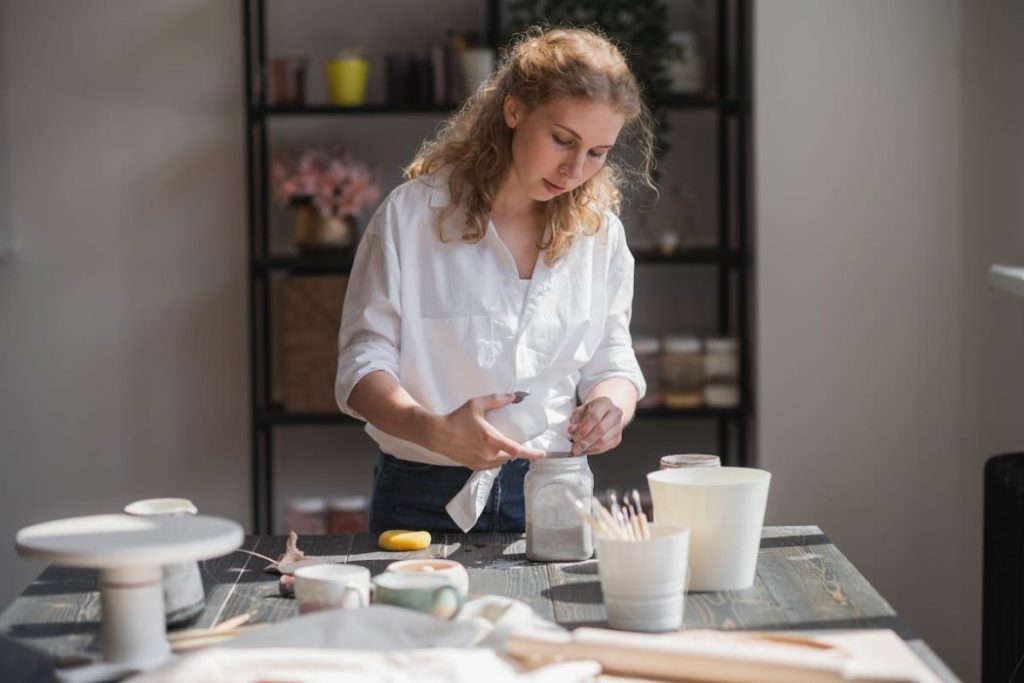 woman making ceramic and pottery tableware at home