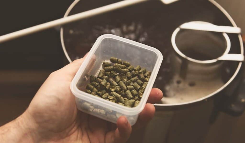 A man brewing craft beer in a kitchen. 