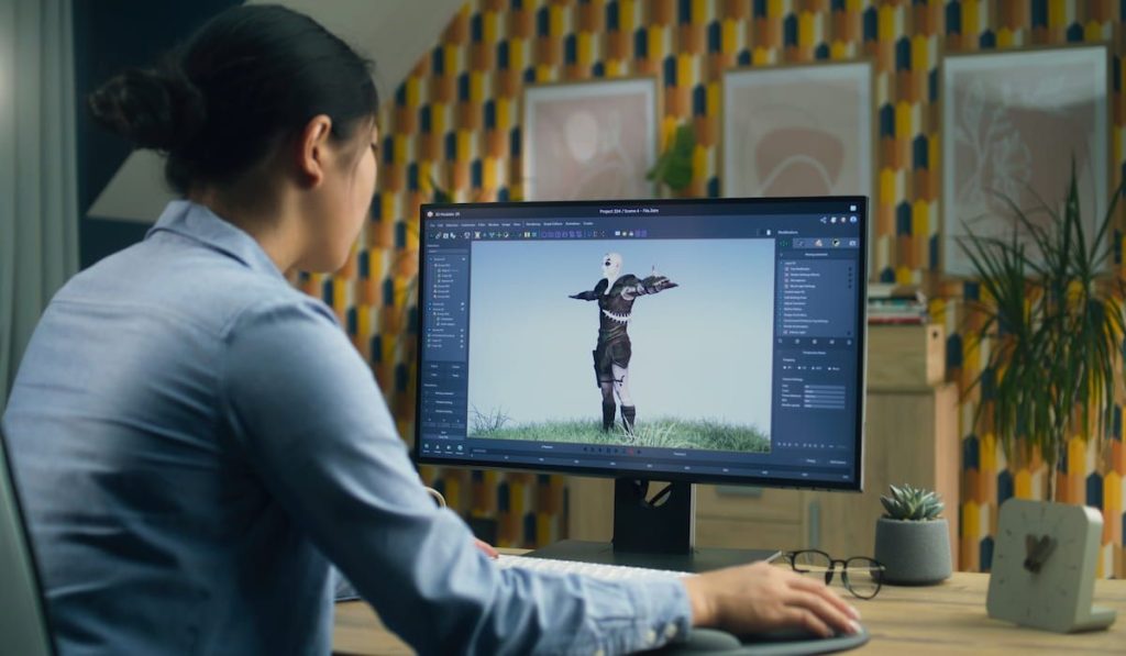 Asian female making 3D animation for video game character using modern computer 