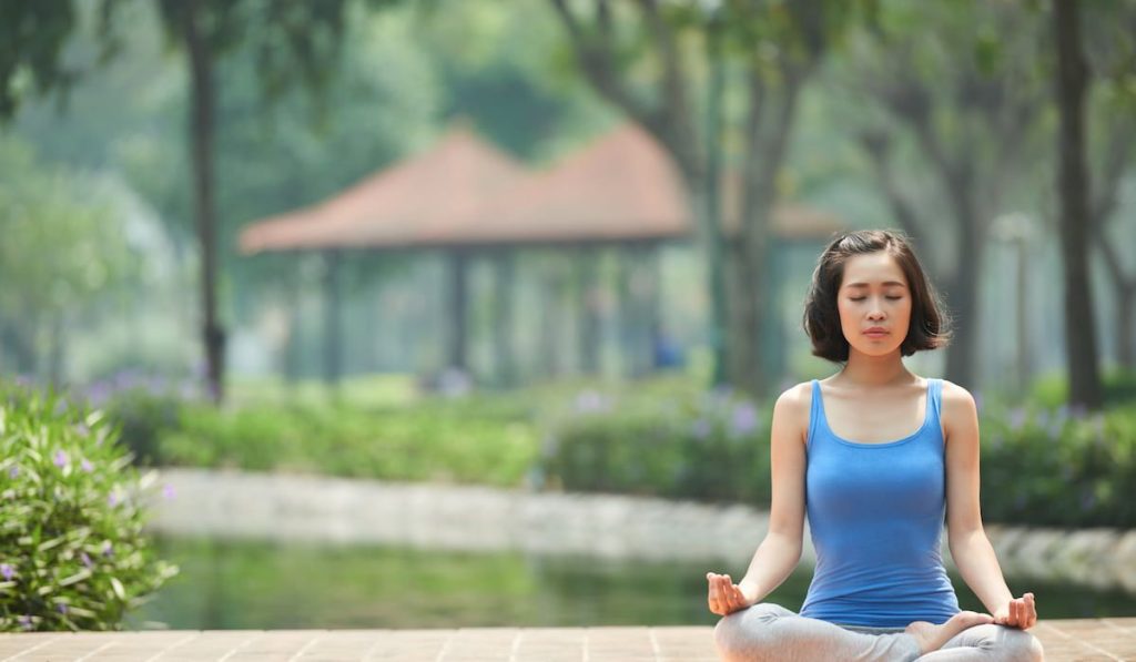 Beautiful woman meditating outdoor