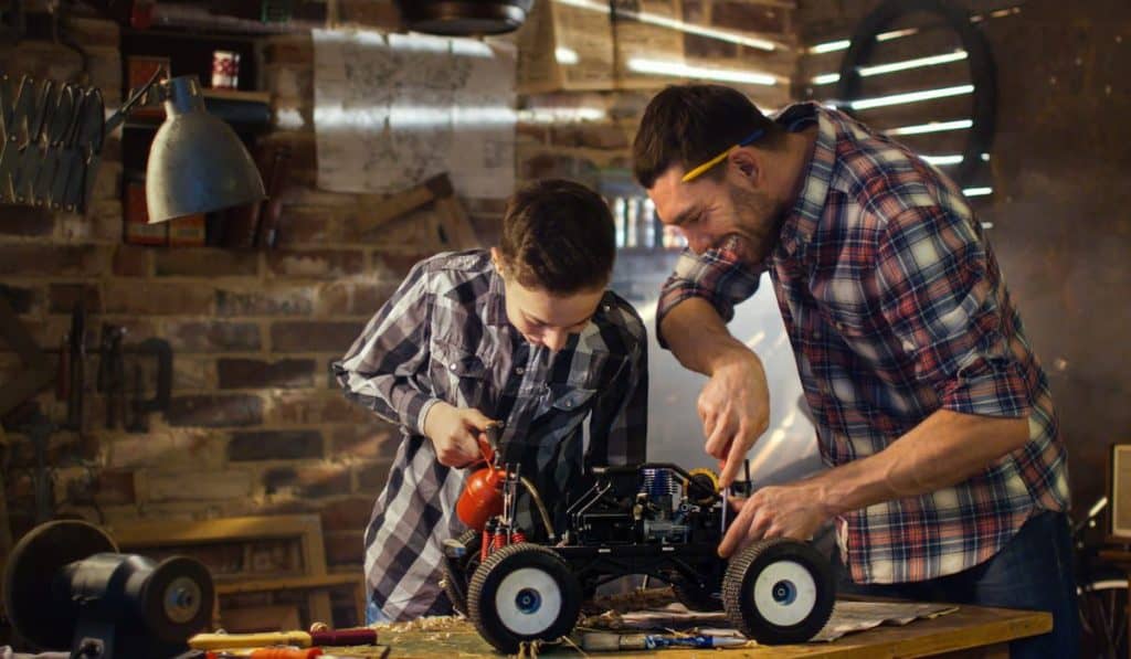 Father and son are working on a radio control toy car