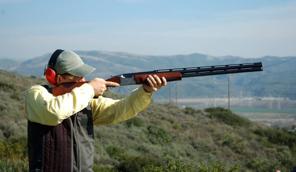 man shooting a shotgun on the trap range