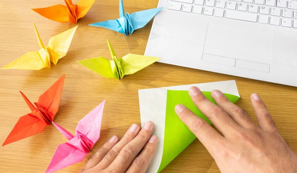 A man's hand making origami