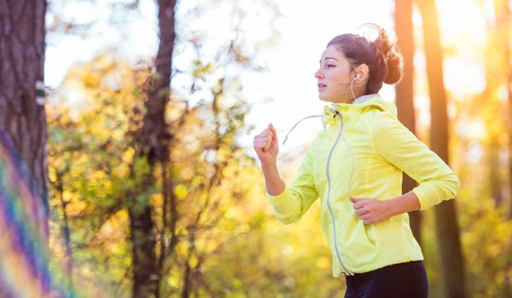 woman running outside in sunny nature