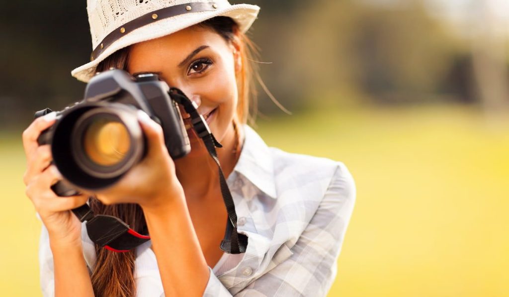 young woman talking pictures outdoors