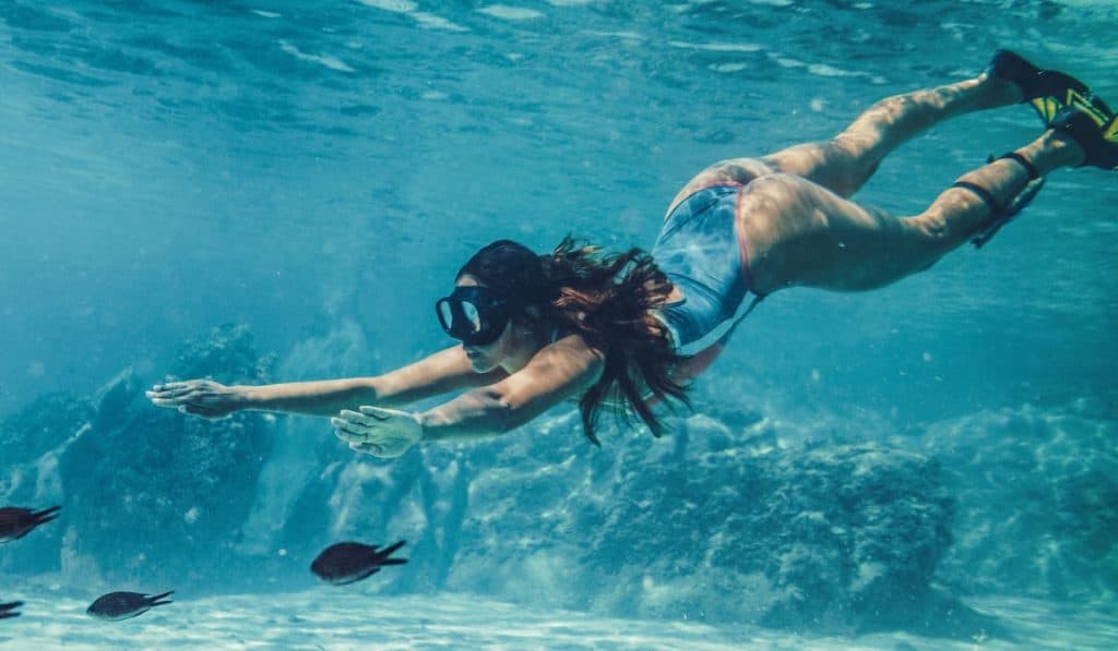 Woman doing freediving exploring the sea