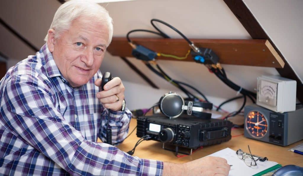 Enthusiastic middle-aged radio-amateur at his station