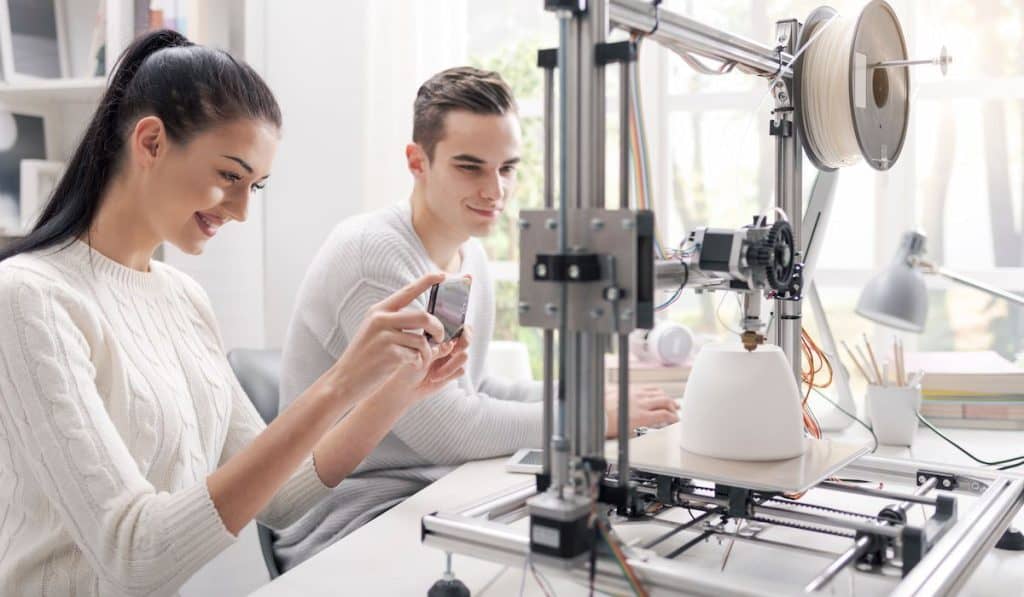 Academic students using a 3D printer in the lab