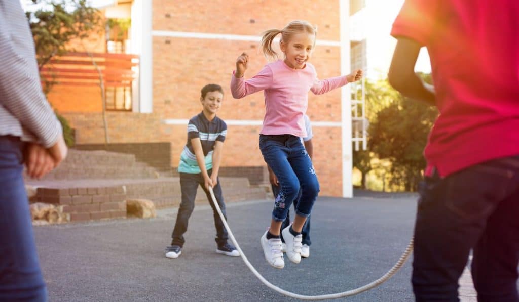 Children playing with skipping rope outdoor