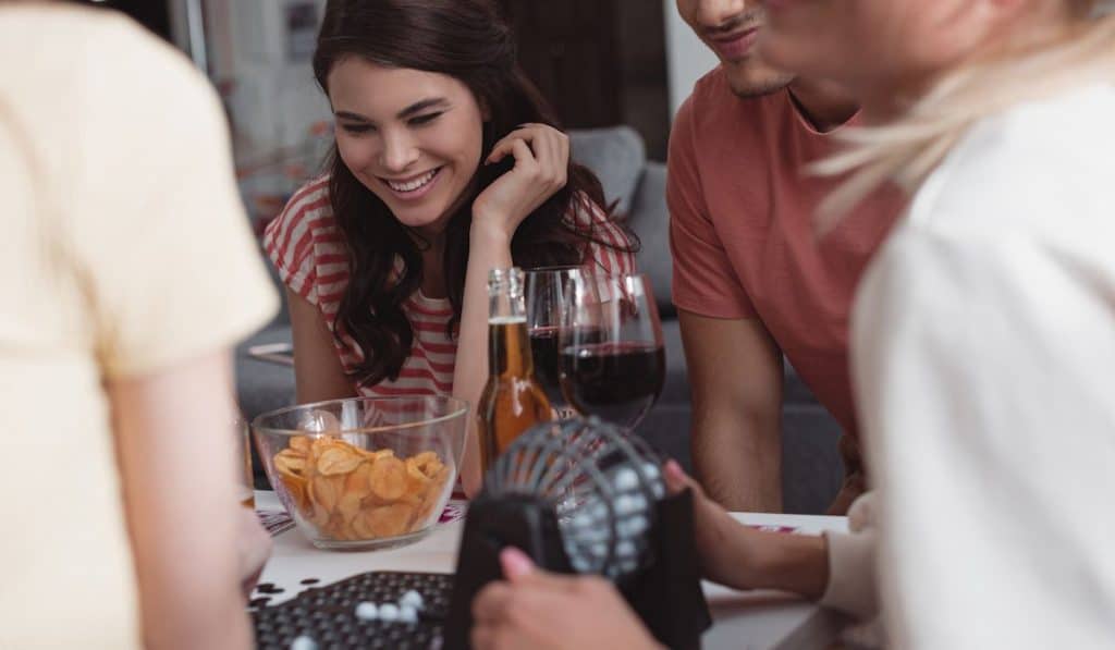 Happy young woman playing with her friends 