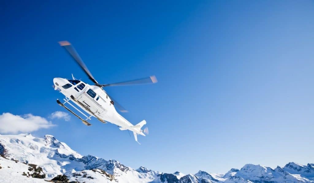 Heli Skiing Helicopter is landing on a ski slope in Gressoney Ski Resort, Aosta, Italy